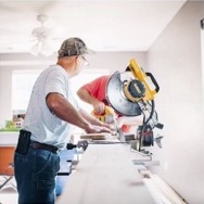 Contractor cutting wood with a mitre saw