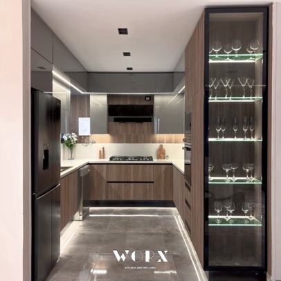 Dark wood kitchen with lit glass display cabinet