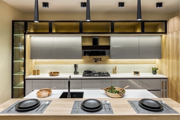 Kitchen island with pendant lights and wood cabinetry