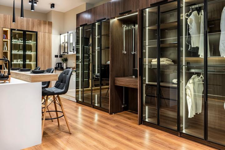 Glass-door walnut wardrobes with a fold-out vanity desk