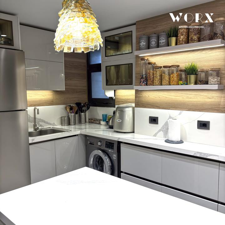 Grey gloss kitchen with oak panelling and lit floating shelves