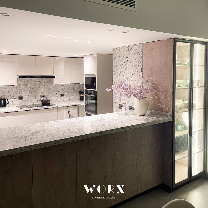 Granite breakfast bar with a lit glass-door display cabinet