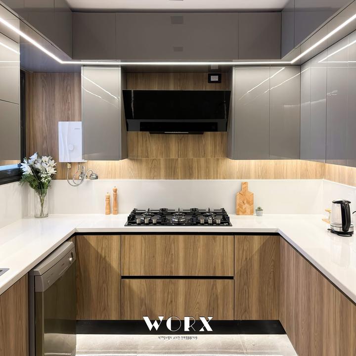 Grey gloss and oak U-shaped kitchen with LED ceiling lines