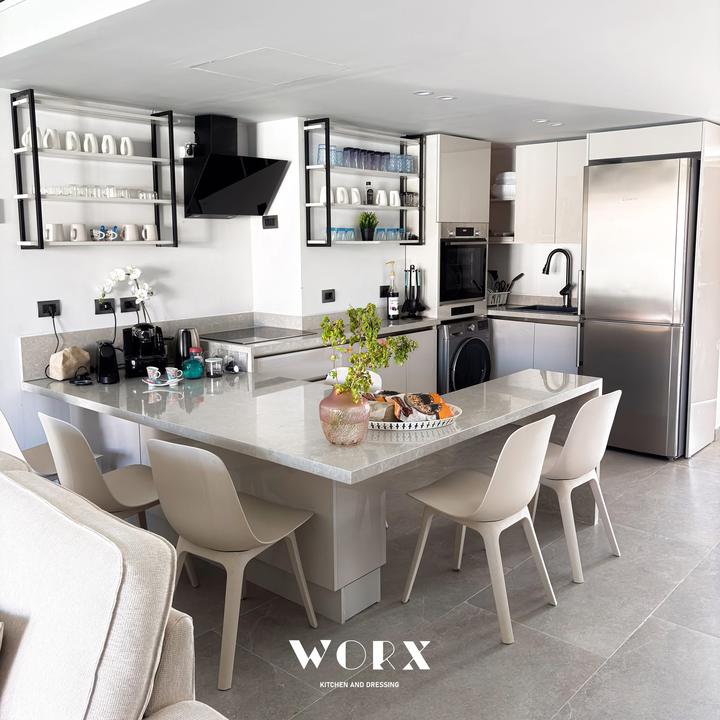 L-shaped stone dining counter with black-framed shelving