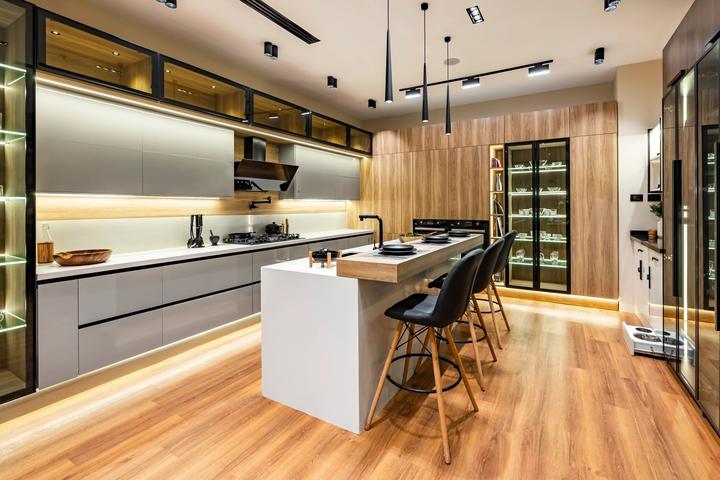 Grey gloss and oak kitchen with white island, wood bar and black pendant lights