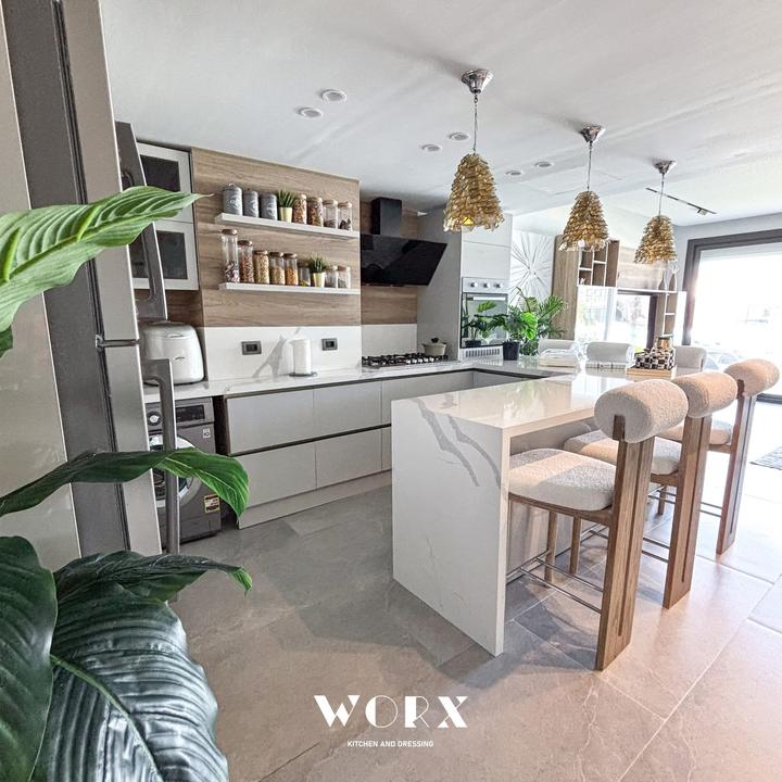 Bright kitchen with waterfall peninsula and wood panelling