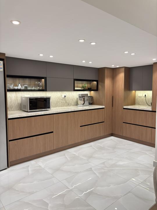 Walnut and grey L-shaped kitchen with lit glass niches